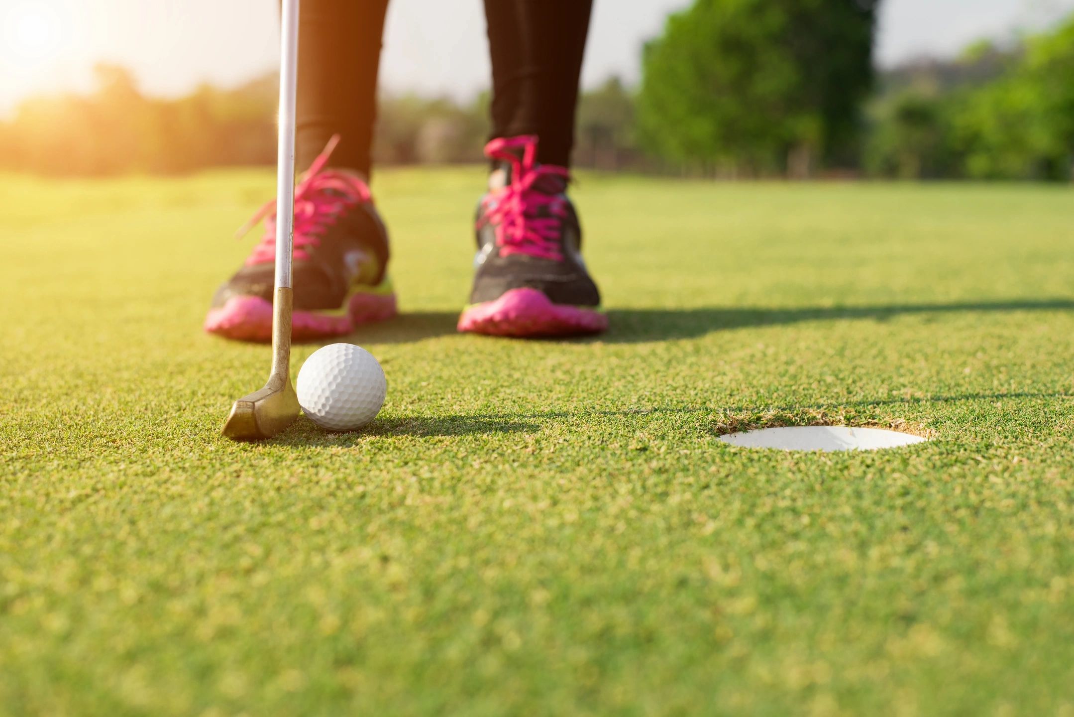 Golfer standing poised on the green, deep in thought before taking a shot, symbolizing the mental game in golf.